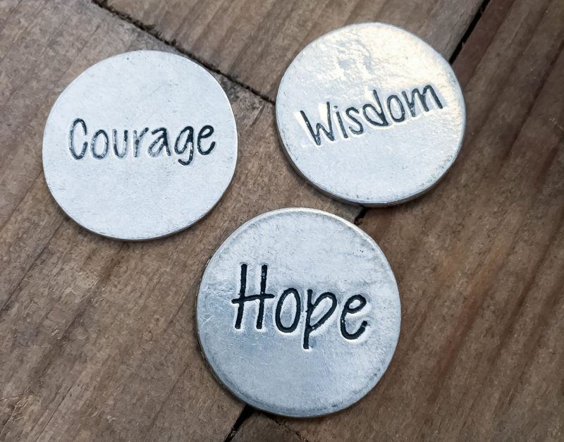 three tokens that say courage, wisdom and hope